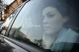 Woman gazing out a car window, lost in thought during a quiet drive — a moment of reflection on life’s shifting seasons.