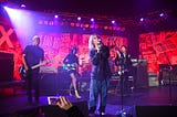 Colored photograph by Kevin Mazur/Getty Images for DG. Violet Grohl, Dave Grohl, Beck, St. Vincent, Krist Novoselic and Pat Smear perform onstage during The Art of Elysium and We are Here Present Heaven is Rock and Roll at Hollywood Palladium on Jan. 4, 2020 in Los Angeles.