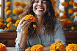 Happy woman surrounded by marigolds.