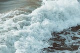 Waves crashing across the ocean surface