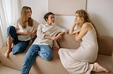 3 women sitting on a sofa chatting