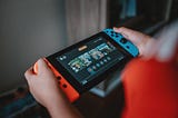 A child’s hands playing with a gaming console, Karen Oliver, Medium