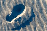 Photograph of a footprint in fine sand.