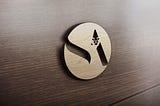 3d Logo of Smith Aegis Plc on wooden wall. Abbreviated S.A with lion shape above the A.