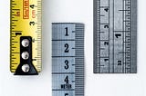 An image of a tape measure and two different types of rulers
