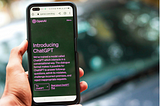 Person holding a phone with ChatGPT open