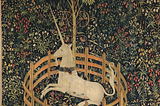 A tapestry depicting a unicorn wearing a collar and trapped by a small circular fence. Behind the unicorn, also in the fenced space, is a small tree. The ground is covered in wildflowers against a dark background.