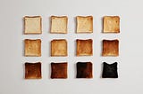 12 pieces of toast ranging from hardly toasted to burnt