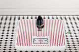 A small-sized girl sitting on a giant weighing scale and feeling depressed.