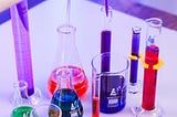 Laboratory glassware with different colored solutions for chemistry analysis