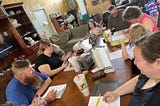 Family gathered around table having discussion