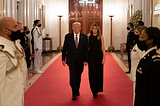Donald and Melania trump walking down red carpet