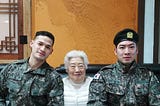 On the left a western looking man on his late 20s, on the middle a Korean grandmother, on the right an asian man on his 30s.