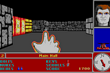 The player character in Catacomb 3D raises their hand to charge a spell, while standing in “The Main Hall” near a locked door. A status display frames the left and bottom portions of the screen.