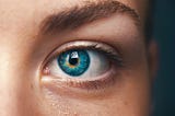 Close-up of a woman’s blue eye.