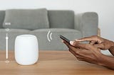 senior couple using voice assistant smart speaker at home