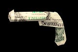 dollar bills folded into the shape of a pistol