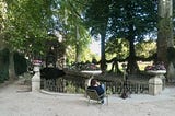 solitary person sat by a fountain