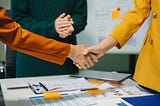Two confident business man shaking hands during a meeting in the office