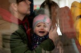 A Ukrainian refugee child reacts as he boards a bus after arriving at Hendaye train station, southwestern France, Wednesday, March 9, 2022. About 200 Ukrainian refugees are arriving in the French Atlantic coast town of Hendaye, where local authorities are greeting them in the train station and offering them temporary lodging. (AP Photo/Bob Edme)