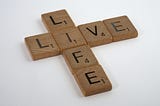 Scrabble tiles that spell Live Life