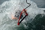 Waterskiier wiping out in a wave of water!