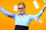 A woman with glasses smiling with bills flying around her
