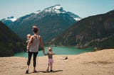 mother and children viewing scenic landscape