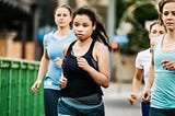 A group of females running demonstrading that they are being active in their workout. Photo by Healthline,