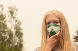 girl wears mask to protect herself from bushfire smoke