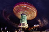 An amusement park ride like a giant swing spinning around- everything is a blur