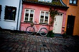 A danish row of homes with a bike.