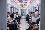 Japanese people being quite and respectful on a train expressing omotenashi.