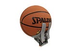Photo of basketball in a prototype 3D printed baskeball prosthethic hand
