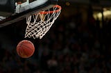 A basketball going through the net