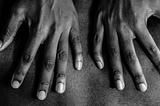 Black hands on back | Photo by Jakayla Toney on Unsplash