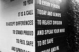 Black and white wall with words.