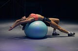 Is it possible to relieve back pain by sitting on an exercise ball?