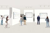 People walk around a museum, looking at displays of similar looking user interfaces.
