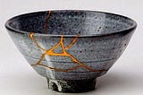 An example of kintsugi. Gold where the broken bowl has been reformed.