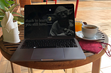 Photo of laptop and cup of coffee in the morning