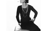 Chanel 1926 in Black Dress, pearls, smoking cigarette