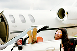 A successful woman with a posh car and a luxury plane doing affiliate marketing
