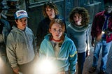 The Hawkins kids gather around a flashlight in Stranger Things Season Four