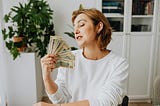 Woman holding a wad of money