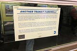 Poster in subway car window announcing “Another Transit Farewell!”