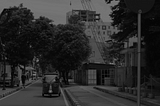 A photo of a three-wheeler going down the street, taken by Muhammad Ilyasa