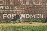 “FOR WOMEN” painted on brick wall | Image from Unsplash | Katherine Hanlon @tinymountain