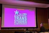 A bright pink slide “The 2nd International Trans Studies Conference”