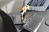 Woman smashing a hammer into an iPad